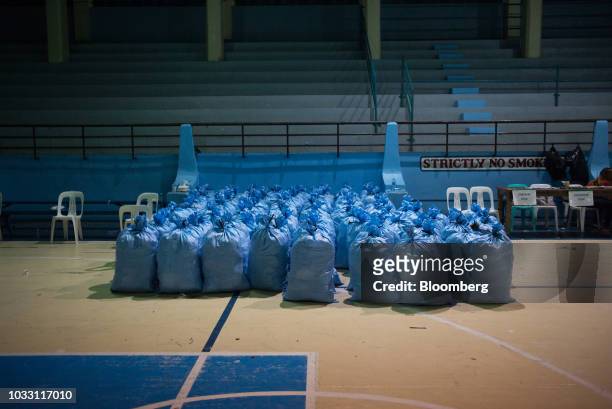 Sacks filled with relief goods sit in a gym awaiting distribution to temporary evacuation centers ahead of Typhoon Mangkhut's arrival in Tuguegarao,...