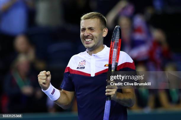 Dan Evans of Great Britain celebrates after match point in his match against Denis Istomin of Uzbekistan during day one of the Davis Cup by BNP...