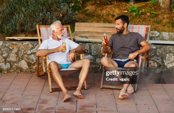 father and son by the pool - drinking in yard stock pictures, royalty-free photos & images