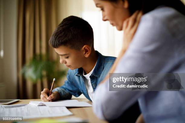 mother helping her son with homework - math homework stock pictures, royalty-free photos & images