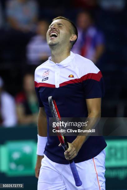 Dan Evans of Great Britain celebrates after match point in his match against Denis Istomin of Uzbekistan during day one of the Davis Cup by BNP...