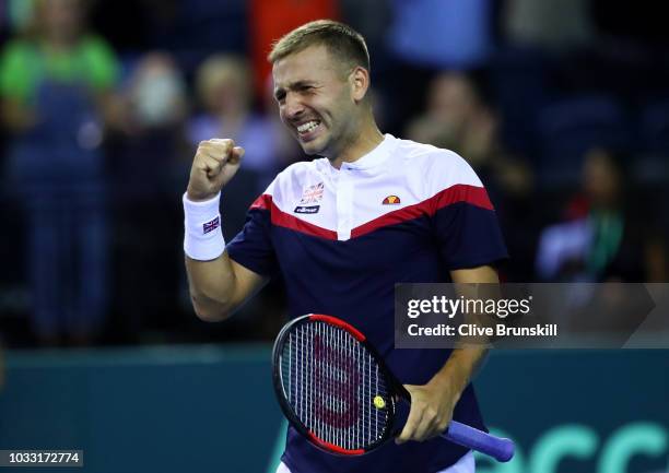 Dan Evans of Great Britain celebrates after match point in his match against Denis Istomin of Uzbekistan during day one of the Davis Cup by BNP...