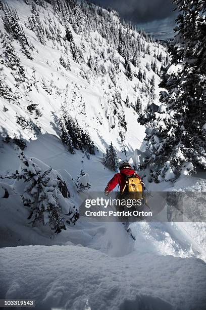 a telemark skier jumping into a narrow chute in montana. - chute ski fotografías e imágenes de stock