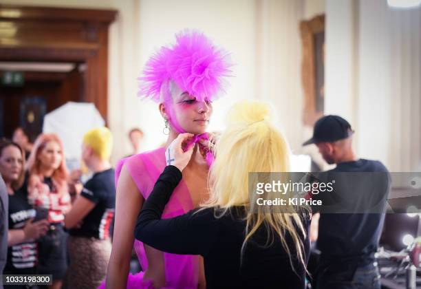 Pam Hogg adjusts a model backstage ahead of the Pam Hogg Show during London Fashion Week September 2018 at Freemasons Hall on September 14, 2018 in...