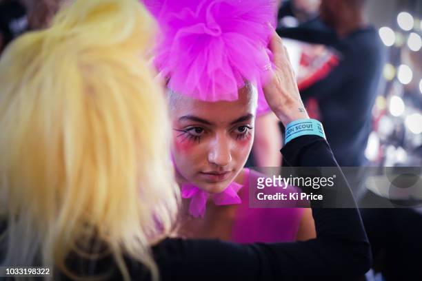 Pam Hogg adjusts a model backstage ahead of the Pam Hogg Show during London Fashion Week September 2018 at Freemasons Hall on September 14, 2018 in...