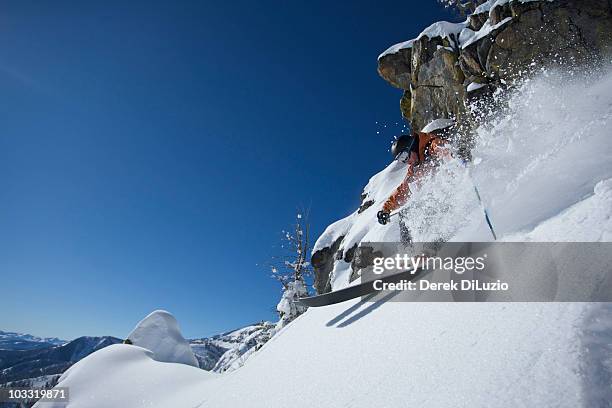 a man skis in powder snow in wyoming. - jackson hole mountain resort stock pictures, royalty-free photos & images