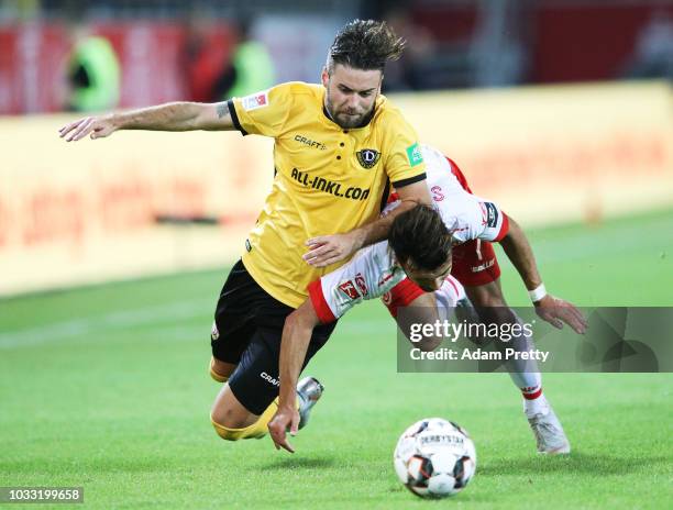 Albion Vrenezi of Jahn Regensburg challenges Niklas Kreuzer of Dynamo Dresden during the Second Bundesliga match between SSV Jahn Regensburg and SG...