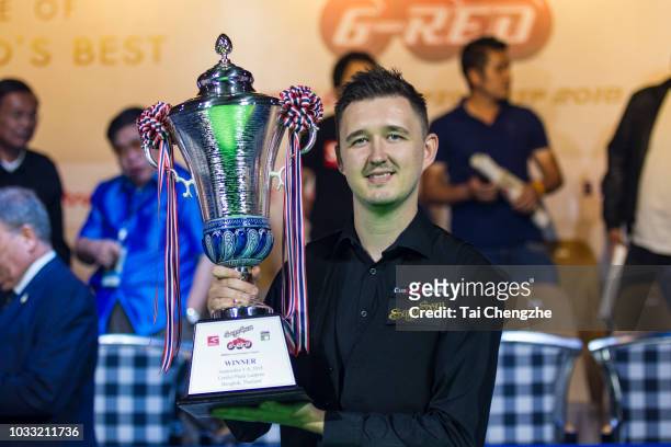 Kyren Wilson of England poses with trophy after winning his final match against Ding Junhui of China on day six of 2018 Six-red World Championship at...