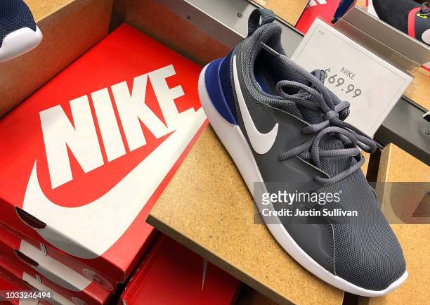 Nike running shoes are displayed at a DSW store on September 14, 2018 in San Francisco, California. A week after Nike released a "Just Do It" ad...