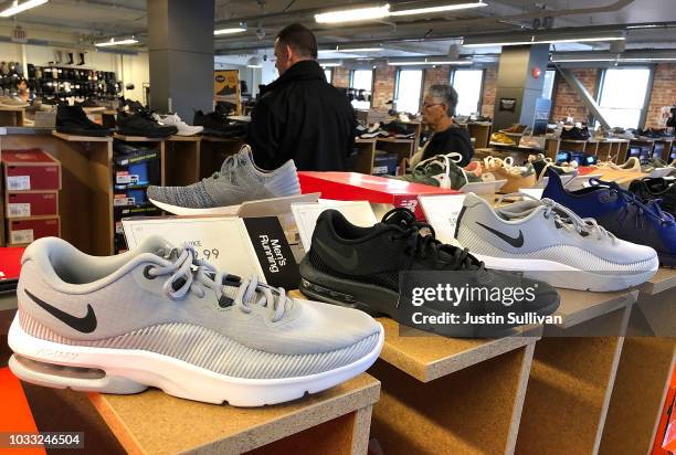 Nike running shoes are displayed at a DSW store on September 14, 2018 in San Francisco, California. A week after Nike released a "Just Do It" ad...