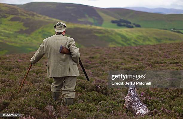Gamekeeper Alex Hogg and his dog Hamish make final preparations for the start of the grouse season on an estate in the Scottish Borders on August 10,...
