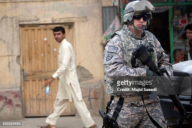 Soldier with the NATO- led International Security Assistance Force arrives at the scene of a suicide bombing at the entrance to a guesthouse on...