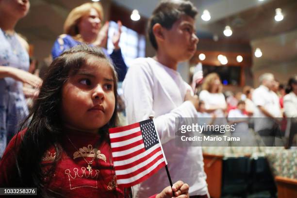 New U.S. Citizen Davies Garcia originally from Mexico, stands with his sister Valerie , a U.S. Citizen born in the U.S., during a naturalization...