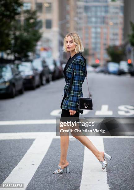 Lisa Hahnbueck wearing checked blazer Tibi, cycle pants, silver Gucci heels, Jimmy Choo Lockett bag is seen during New York Fashion Week...