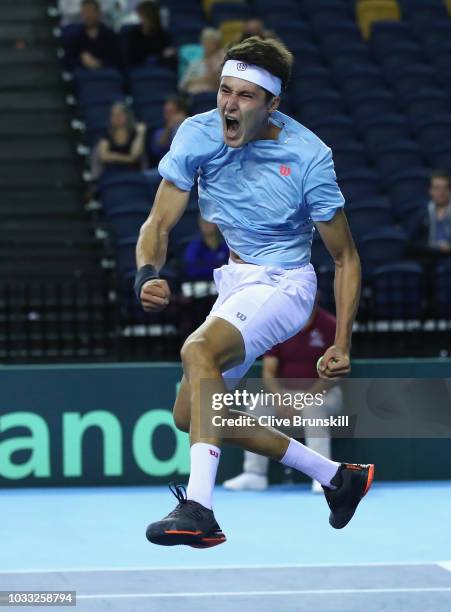 Jurabek Karimov of Uzbekistan celebrates match point against Cameron Norrie of Great Britain during day one of the Davis Cup match between Great...