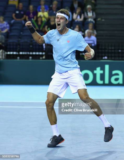 Jurabek Karimov of Uzbekistan celebrates match point against Cameron Norrie of Great Britain during day one of the Davis Cup match between Great...