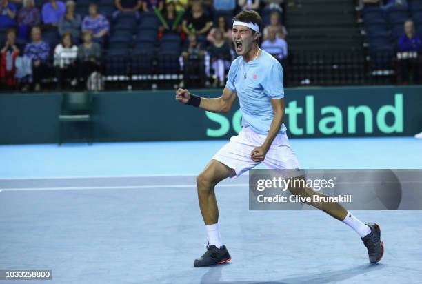 Jurabek Karimov of Uzbekistan celebrates match point against Cameron Norrie of Great Britain during day one of the Davis Cup match between Great...