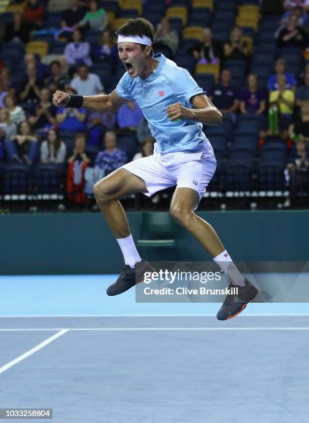 Jurabek Karimov of Uzbekistan celebrates match point against Cameron Norrie of Great Britain during day one of the Davis Cup match between Great...