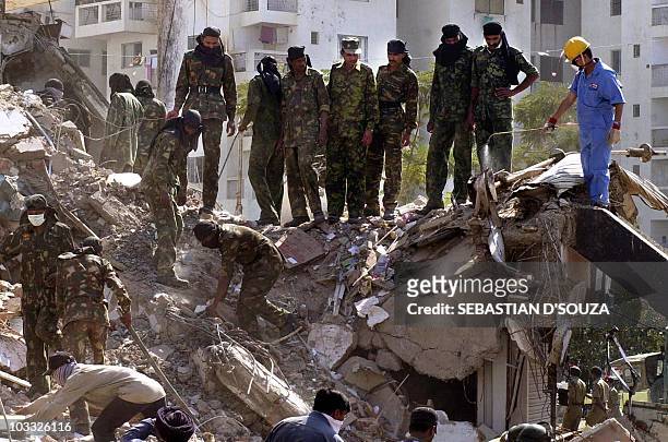 Members of the Indian army search for survivors and bodies the debris of a ten storey apartment block 29 January 2001 in Ahmedabad following the...