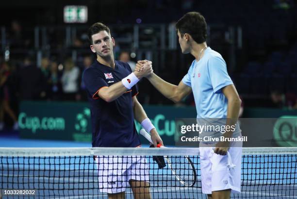 Jurabek Karimov of Uzbekistan shakes hands at the net after his five set victory against Cameron Norrie of Great Britain during day one of the Davis...