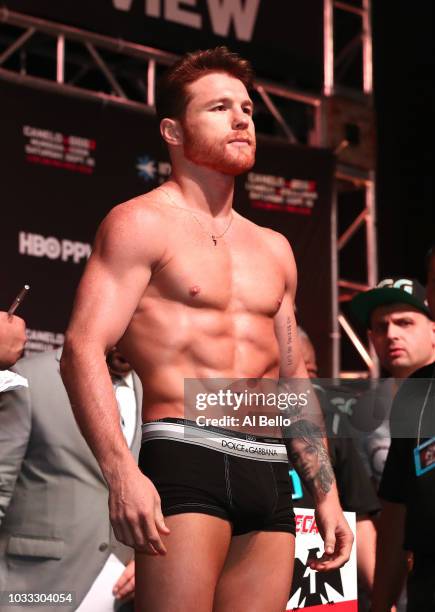 Canelo Alvarez poses on the scale during his official weigh-in at T-Mobile Arena on September 13, 2018 in Las Vegas, Nevada. Alvarez will challenge...