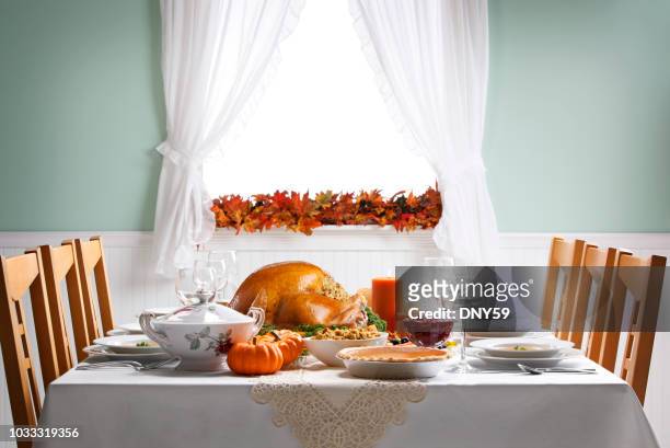 turkey as centerpiece for a thanksgiving feast - dining table stock pictures, royalty-free photos & images