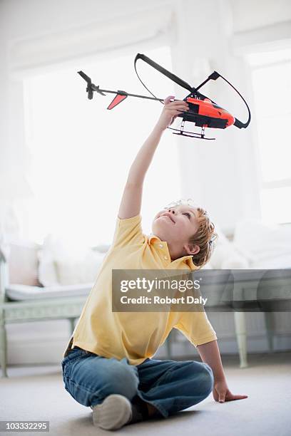 boy playing with toy helicopter - playing toy men stockfoto's en -beelden