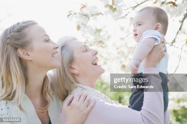 smiling grandmother, mother and son - active baby boomer stock pictures, royalty-free photos & images