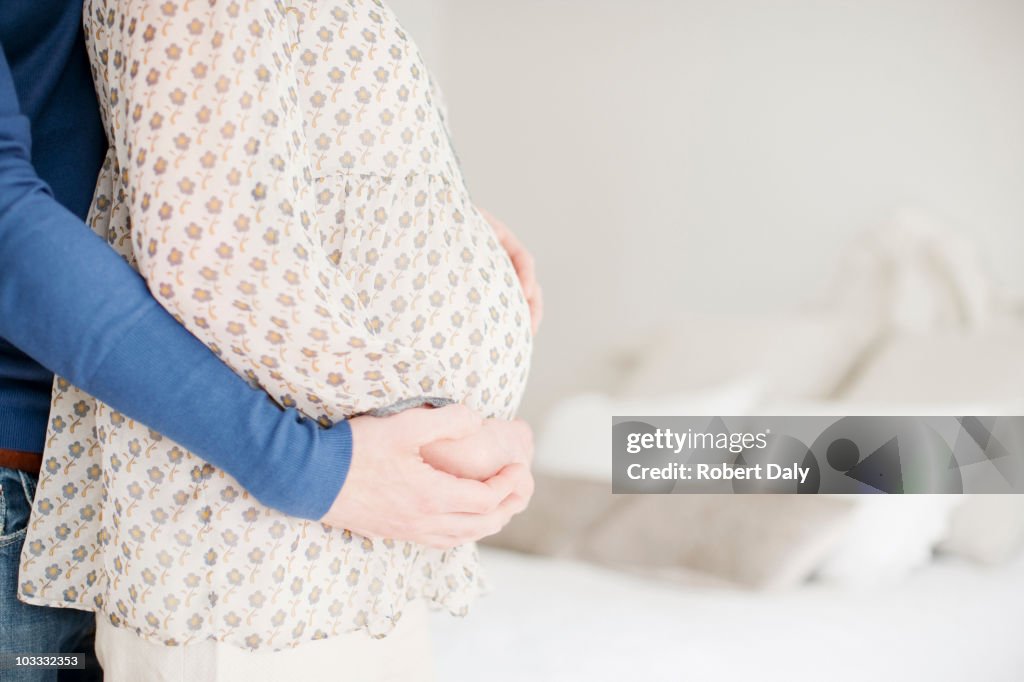 Husband holding hands with pregnant wife