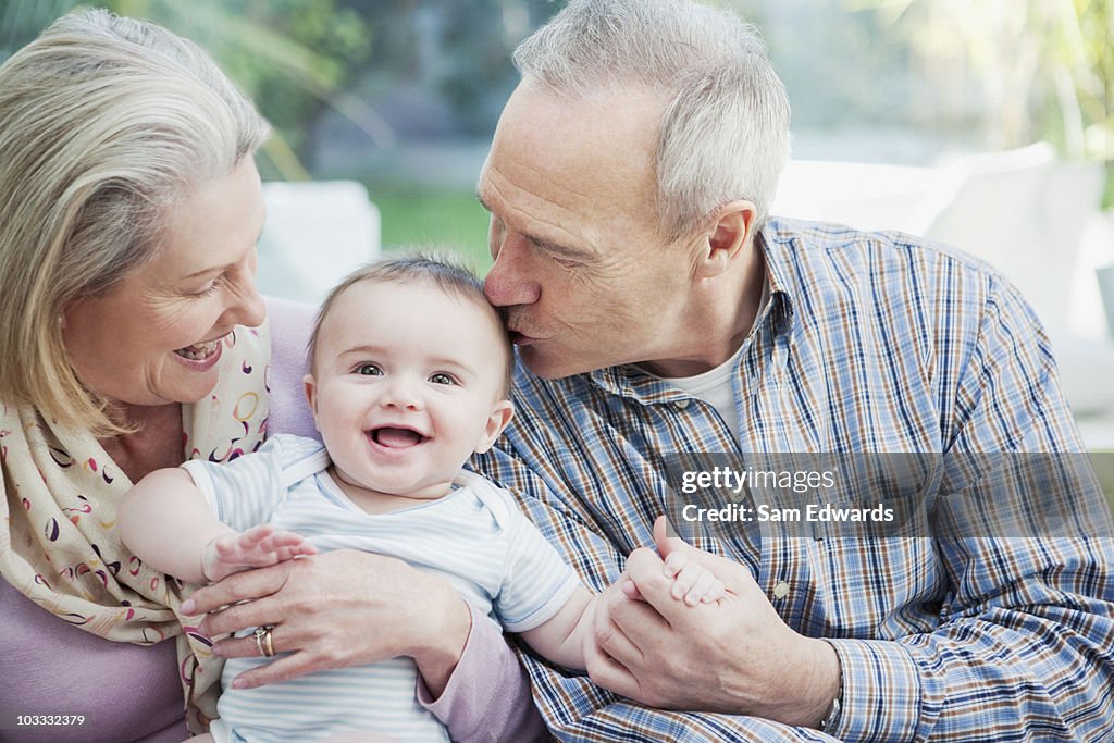 Grandparents holding baby grandson