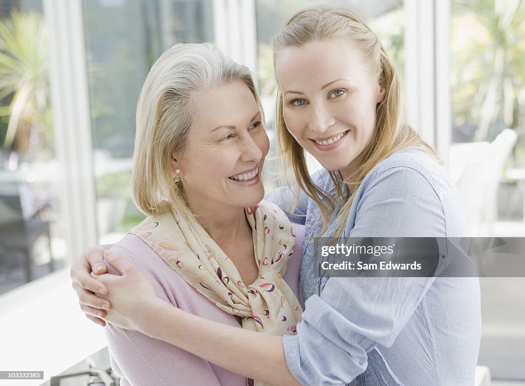 Smiling mother and daughter hugging