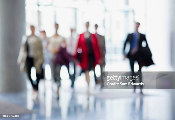 business people walking in lobby - arrival stock pictures, royalty-free photos & images