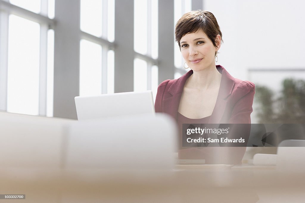 Smiling businesswoman using laptop