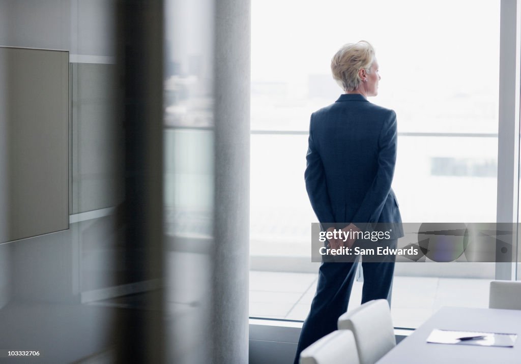 Businesswoman standing at window in office