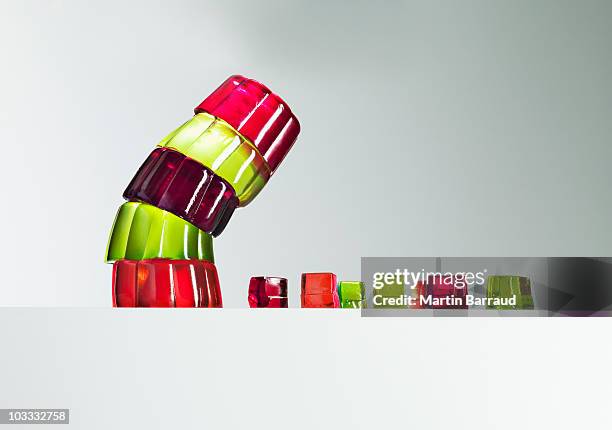 stack of vibrant gelatin dessert leaning over small gelatin dessert cubes - ominous bildbanksfoton och bilder