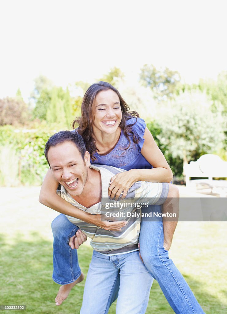 Man giving girlfriend piggyback ride