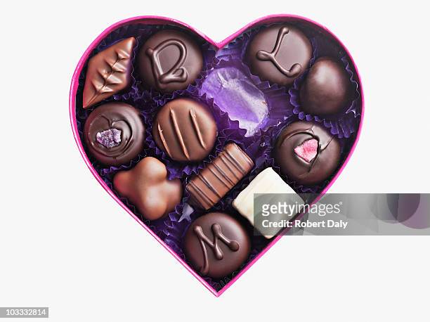 close up of chocolates in heart-shape box - chocolate stock pictures, royalty-free photos & images