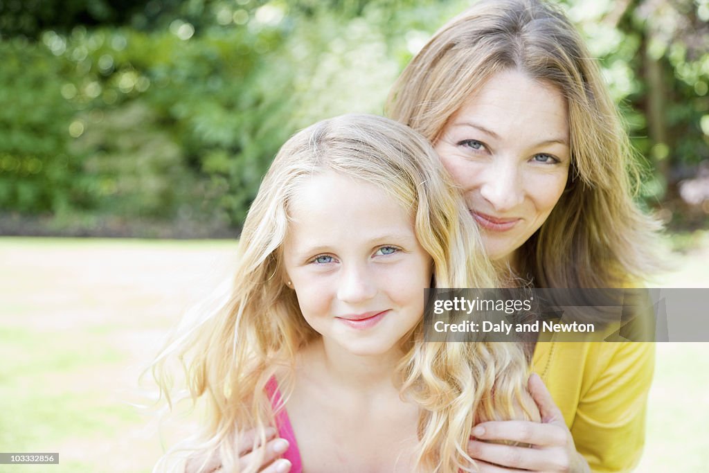 Smiling mother hugging daughter