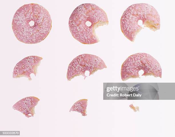 sequence of bites taken from pink donut - bite mark stock pictures, royalty-free photos & images