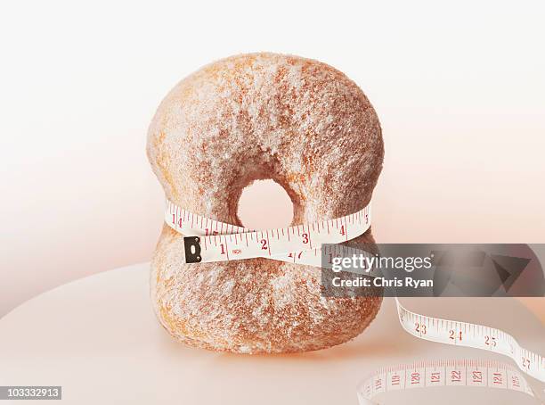 tape measure squeezing donut - around waist stock pictures, royalty-free photos & images