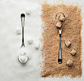 Contrasting sugar, turbinado sugar and sugar cubes with spoons