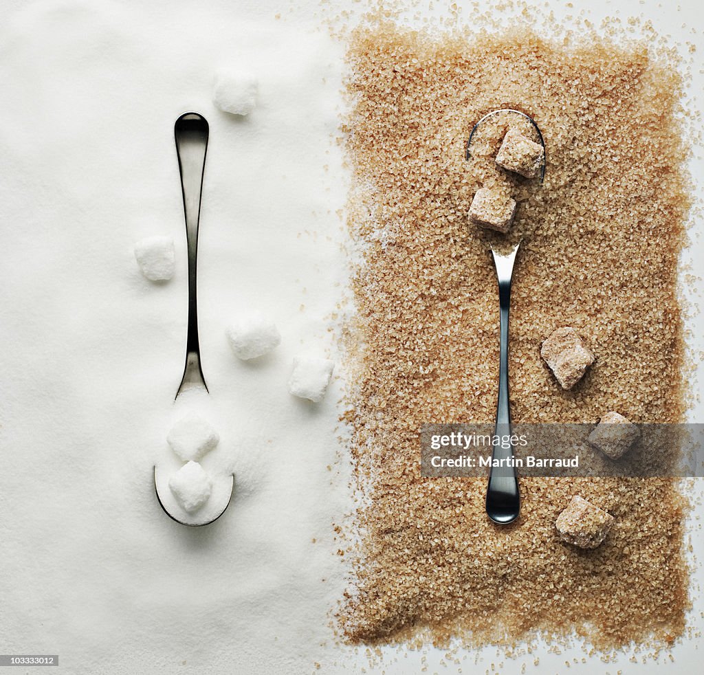 Contrasting sugar, turbinado sugar and sugar cubes with spoons