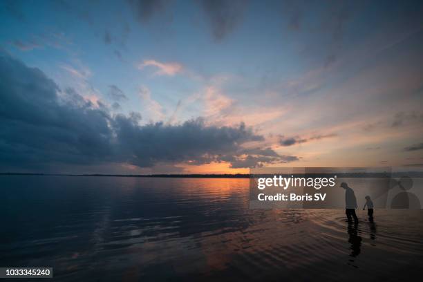 collecting stones in shallow waters - ottawa landscape stock pictures, royalty-free photos & images