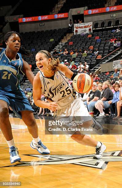 Becky Hammon of the San Antonio Silver Stars drives against Nicky Anosike of the Minnesota Lynk on August 10, 2010 at the AT&T Center in San Antonio,...