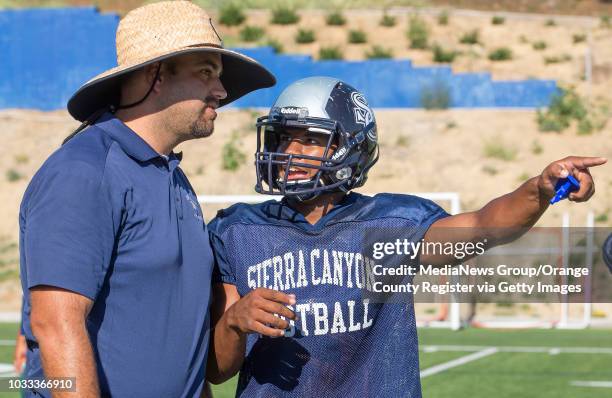 Sierra Canyon head football coach Jon Ellinghouse, left, speaks with running back Joshua Cole during a recent practice. ///ADDITIONAL INFORMATION:...