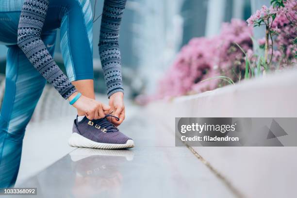 tying shoelaces - tying stock pictures, royalty-free photos & images