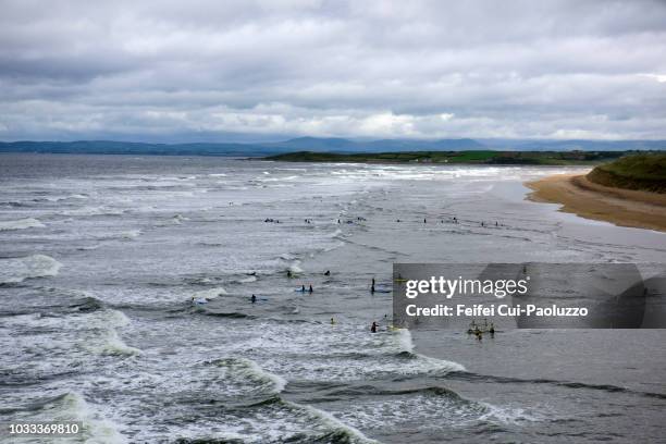 people swimming in the ocean at bundoran of donegal county in ireland - ireland surf wave stockfoto's en -beelden