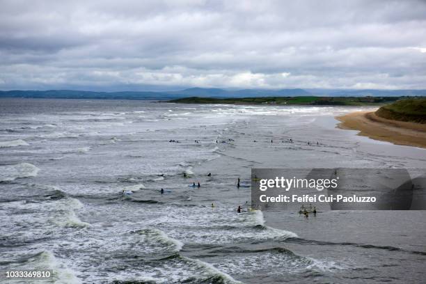 people swimming in the ocean at bundoran of donegal county in ireland - bundoran county donegal stock pictures, royalty-free photos & images