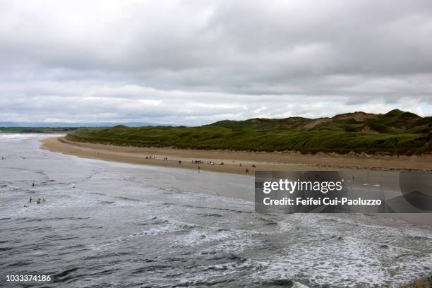 people swimming in the ocean at bundoran of donegal county in ireland - bundoran ireland stock pictures, royalty-free photos & images