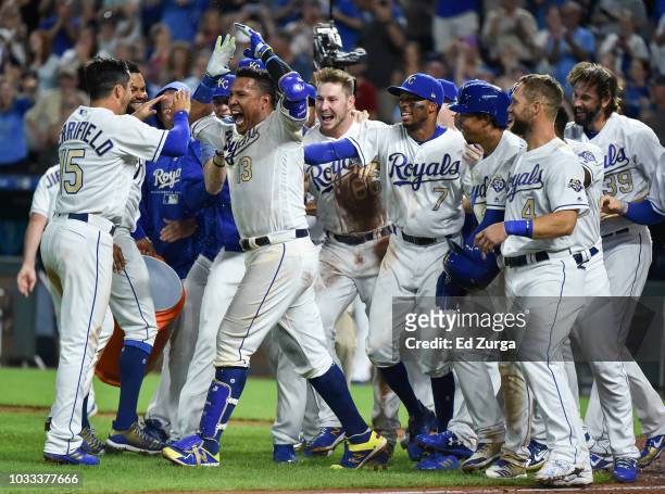 Salvador Perez celebrates with Whit Merrifield and members of the Kansas City Royals as he celebrates his walk-off grand slam against the Minnesota...